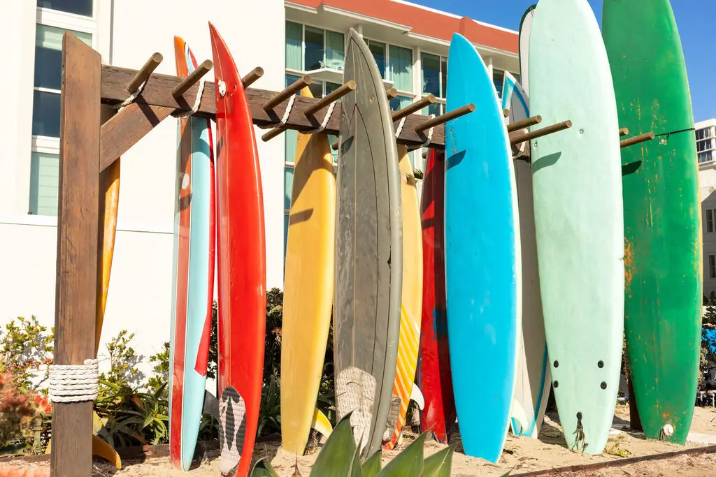 Surfboards on a rack beside a building.